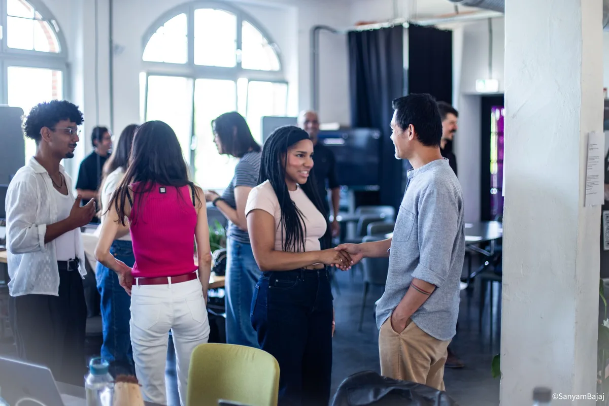 Workshop attendees meeting and shaking hands